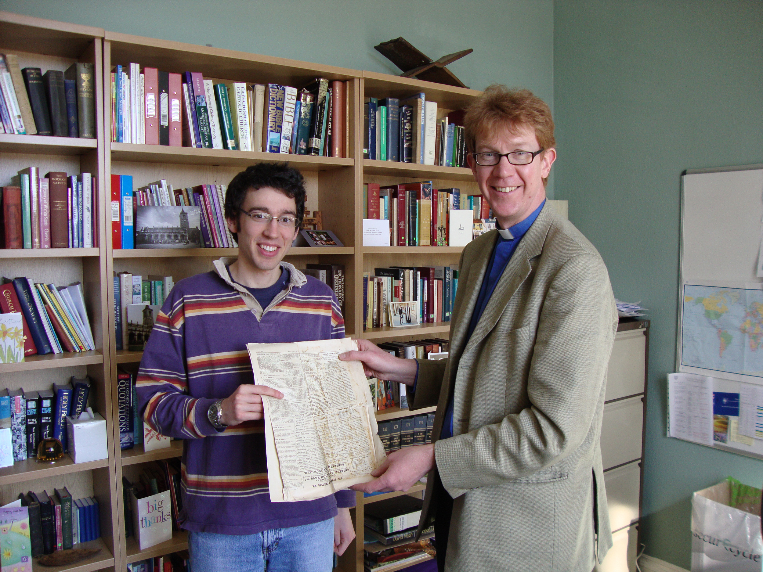 Peter Reader-Harris (left), great-great grandson of Richard Reader Harris, with University Chaplain Revd Dr Donald MacEwan (right) and the pages of Tongues of Fire.
