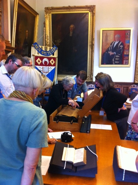 Biblical scholars examine a Hebrew Scroll during a workshop session in the Senate Room.
