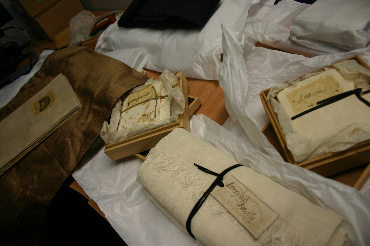 Several of Johnstone's books in their various housings: cloth, wooden boxes and paper.