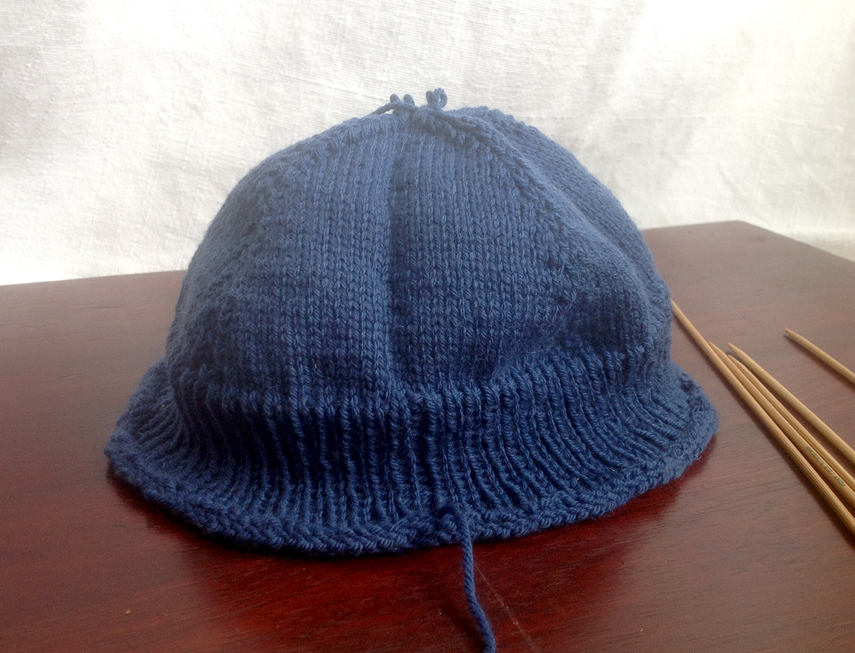The “finished” cap.  Sadly too short to fit an adult head, this one is destined to be unravelled and knitted up with a much longer ribbing.