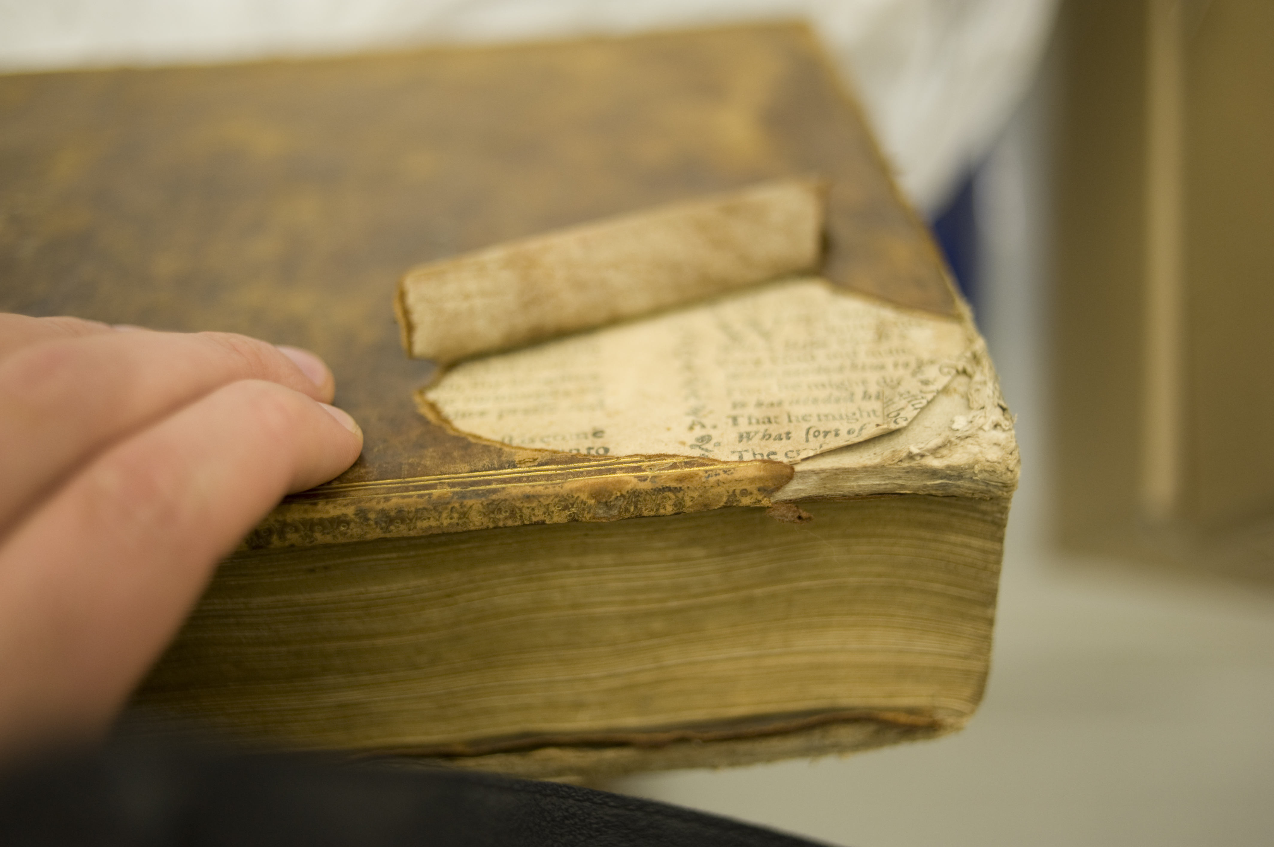 Torn leather on the back board of St Andrews r17 DG676.3M7 revealed more sheets of the same catechism had been used to make the boards of this book.