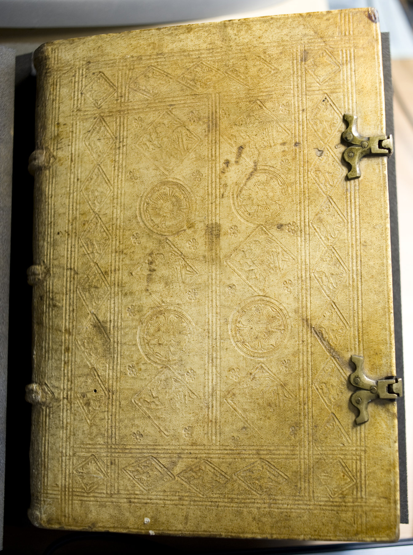The front board of vol. 1 of the 1489 printing of Alexander of Hales's Summa universae theologiae; bound in pigskin on wooden boards and decorated with various blind stamps.