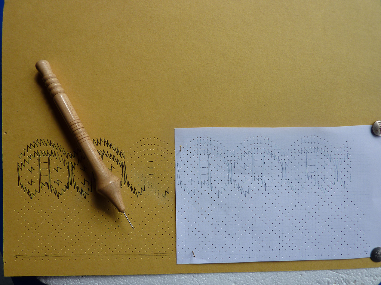 The pattern being pricked out onto card