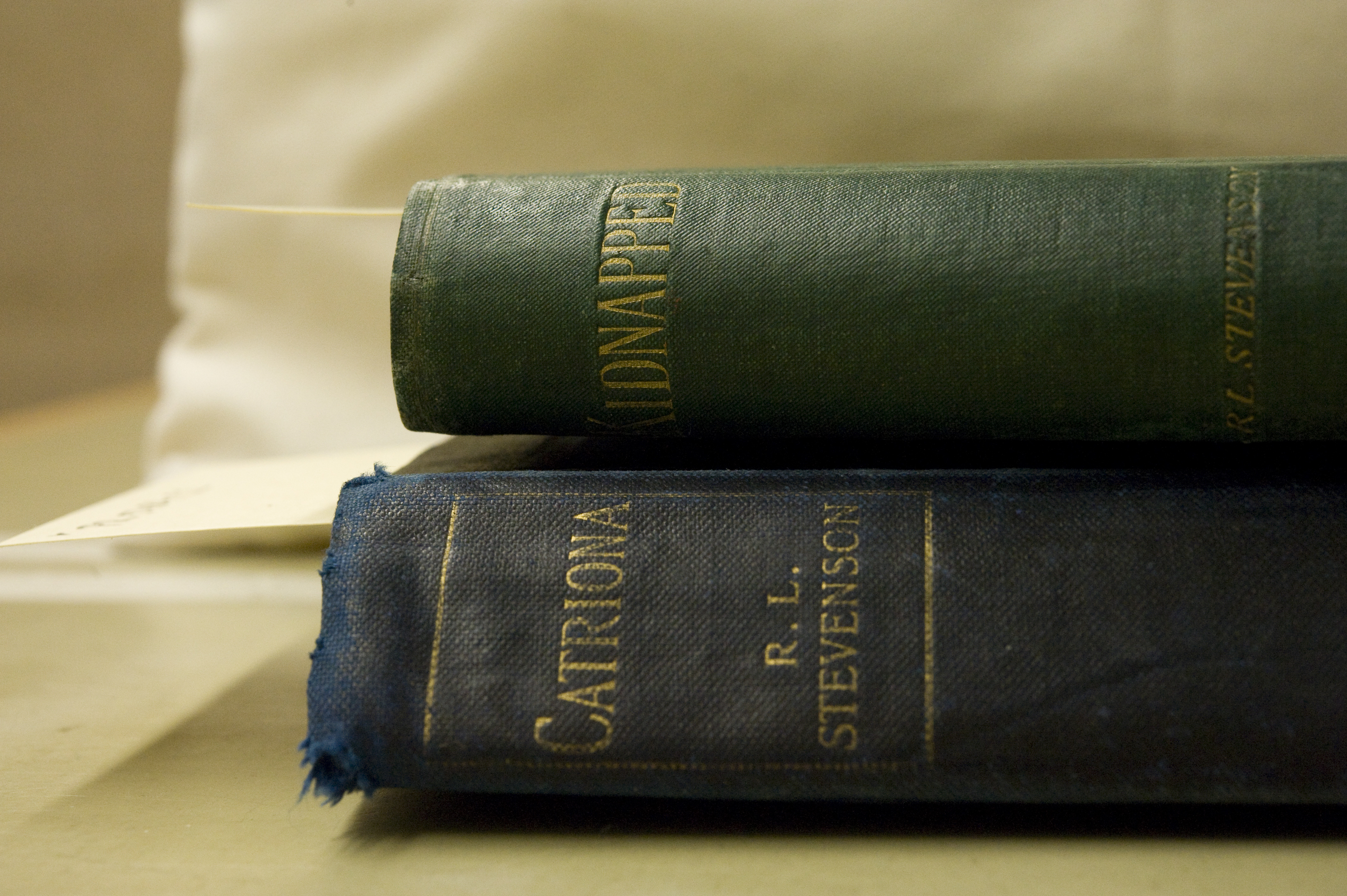 The spine titles of St Andrews' copies of the first editions of Kidnapped and Catriona