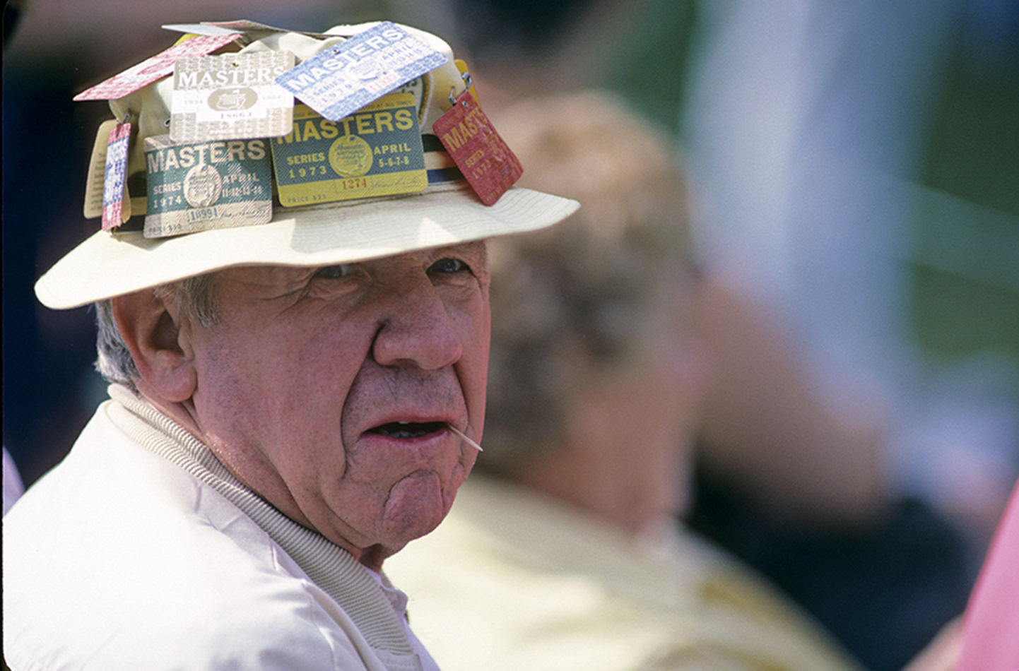 A veteran of many Masters, this patron chews a toothpick at the 1985 Masters (Photograph © Lawrence Levy Photographic Collection. All rights reserved.  Image courtesy of the University of St Andrews Library, [2008-1-1764]).