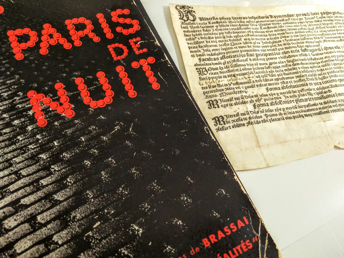 My two favourite acquisitions as Rare Books Librarian side-by-side: the inky, murky noir delight that is Brassaï's Paris de Nuit (1933) & a 1487 indulgence, printed on vellum in Cologne and issued to a "Johan le Brebsotte" and his wife